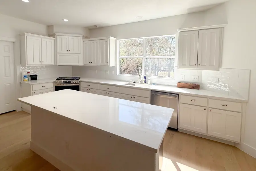 Freshly painted white kitchen cabinets and walls in a Knoxville home by That 1 Painter