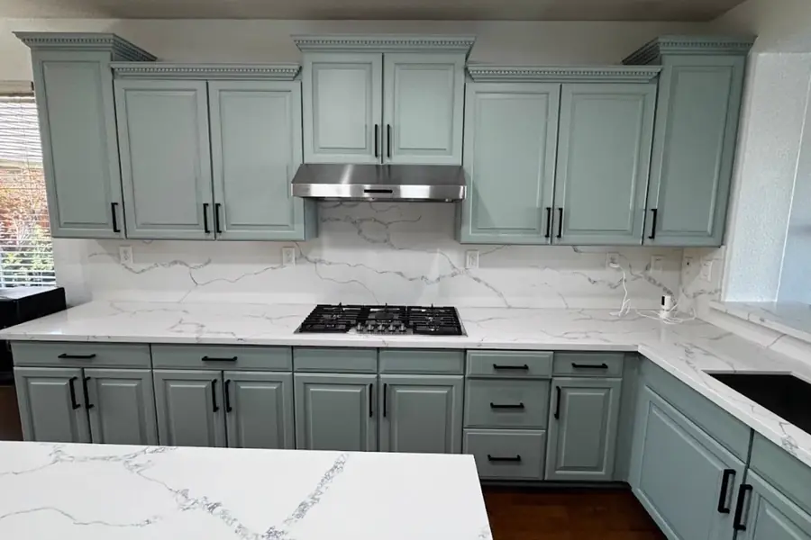 Kitchen cabinets painted sage green with crisp trim in a Knoxville area home